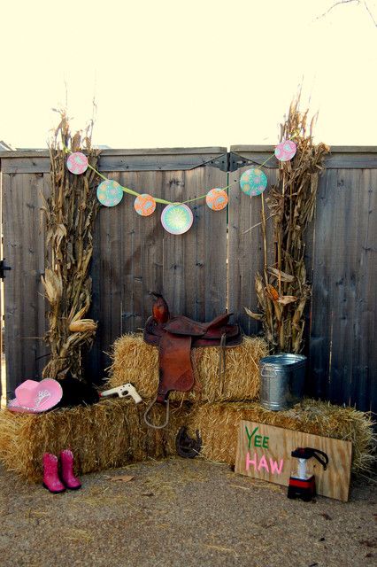 hay bales are stacked on top of each other in front of a wooden fence