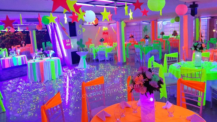 an indoor party with neon colored tables and chairs