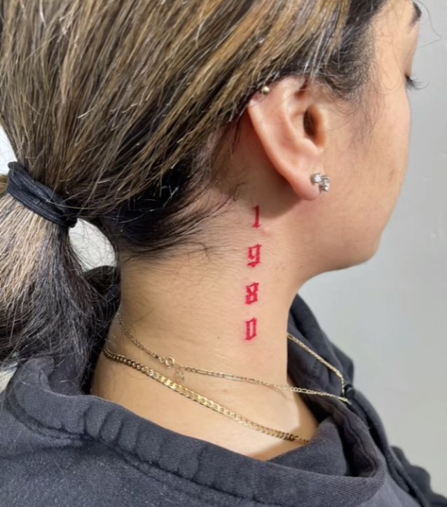 the back of a woman's neck is shown with red ink on her left side