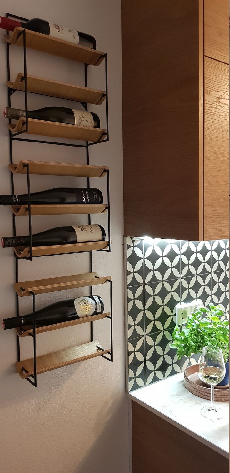 a wall mounted wine rack with bottles on it