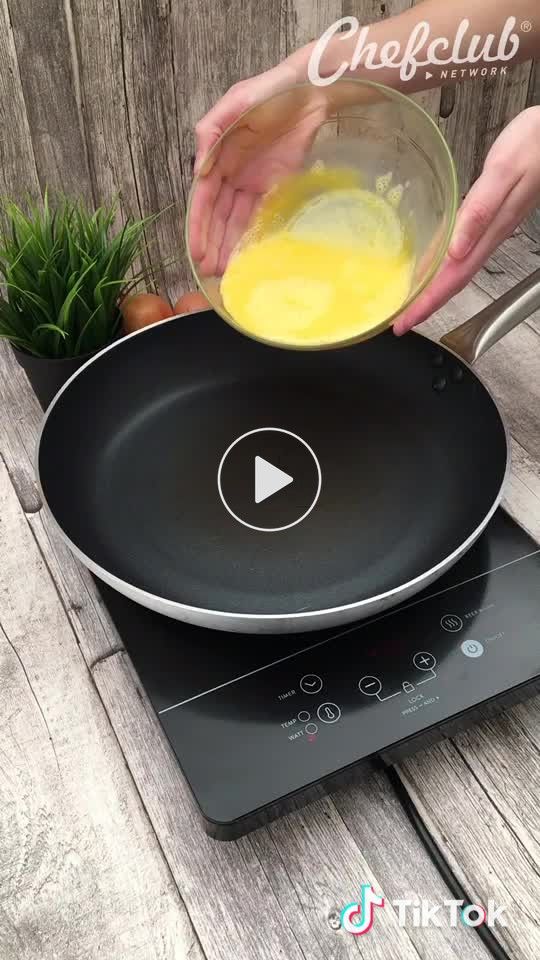 someone is mixing eggs in a pan on top of an electric cooktop with the words cheeflub above it