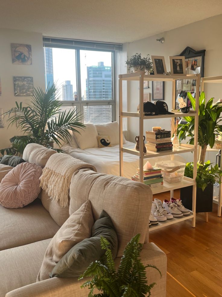 a living room filled with lots of furniture and plants on top of it's shelves