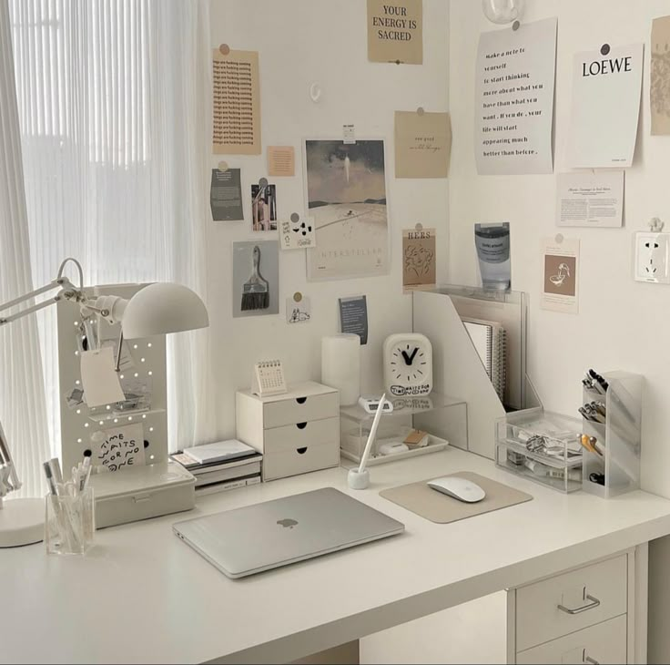 a white desk with a laptop computer on top of it