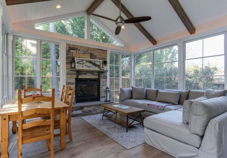 a living room filled with furniture and a fire place in the middle of a room