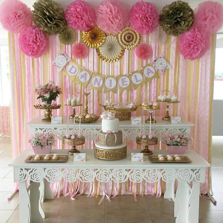 a dessert table with pink and gold decorations