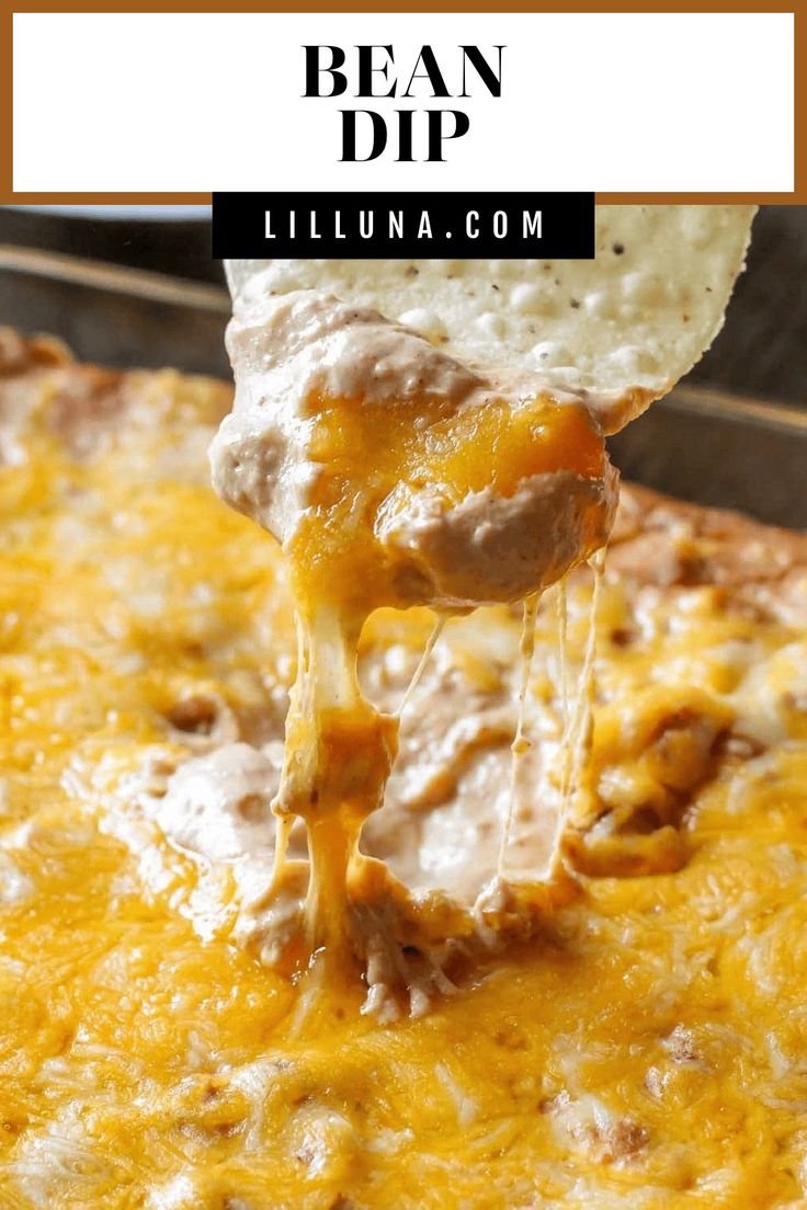 a tortilla casserole with cheese being lifted from it by a tortilla chip