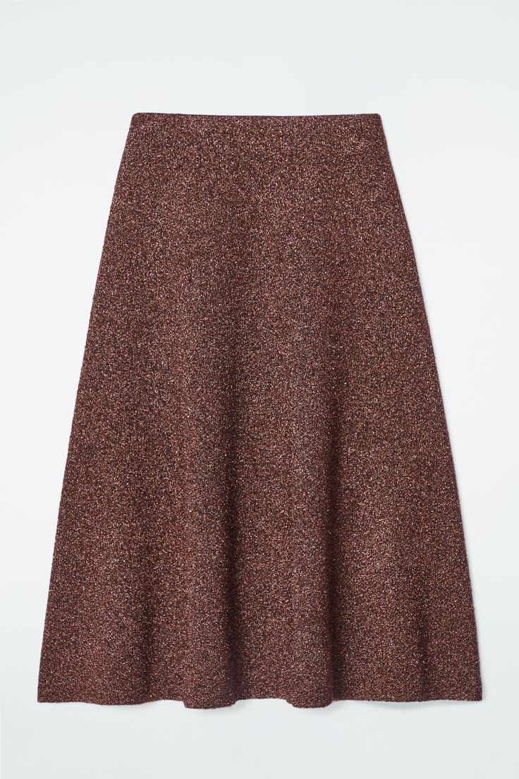 A prelude to party season, this midi skirt is knitted from premium merino wool with metalized fibers that beautifully catch the light. It's double-faced with a soft camel-hued interior and cut in a voluminous A-line shape. Style it with the coordinating cardigan for maximum impact. Regular fitThis product contains Responsible Wool Standard TE-00047206 (RWS) wool fiber from farms certified to animal welfare and land-management requirements Shell: 55% Merino wool, 23% Metalized fiber, 18% Recycled Wool Midi Skirt, Land Management, Brown Interior, Wool Skirt, Vest Shirt, Animal Welfare, Wool Skirts, Cardigan Coat, Trouser Jeans