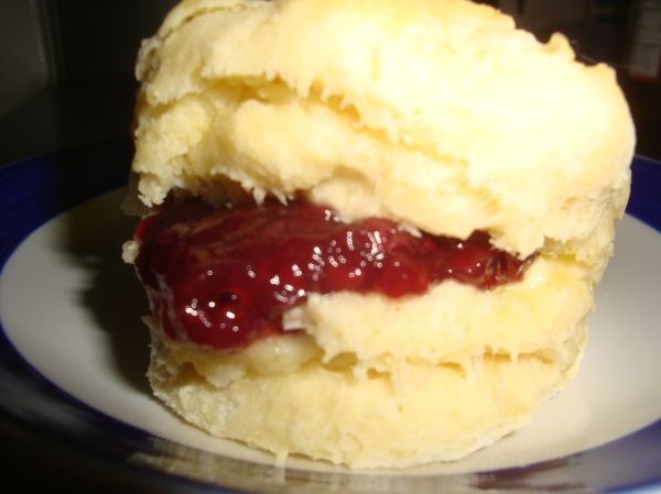 a close up of a doughnut on a plate with ketchup in the middle