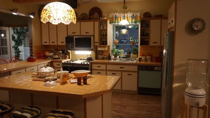 a kitchen filled with lots of appliances and counter top space next to a dining room table