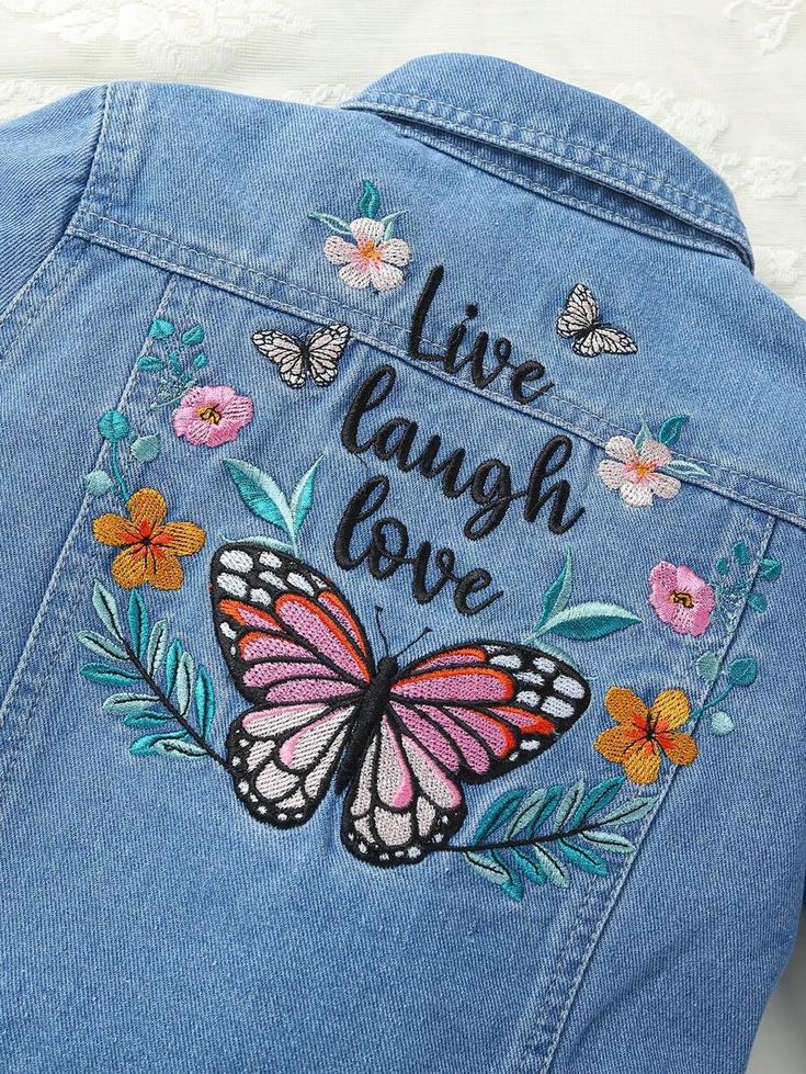 the back of a jean jacket with embroidered butterflies and flowers on it that says, live laugh love