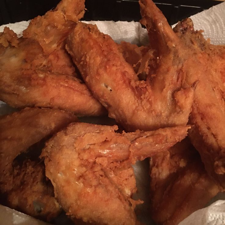 some fried chicken pieces are in a basket