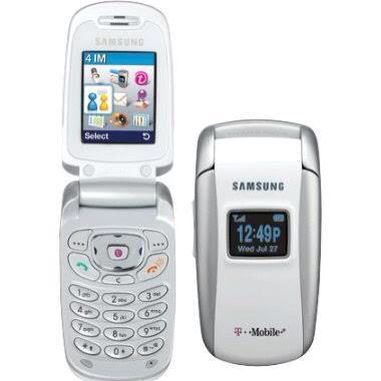 a samsung flip phone next to an older cellphone with the time displayed on it