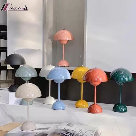 several different colored lamps are on display in front of a mirror