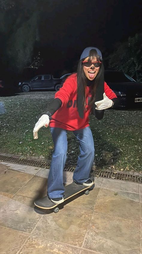 a woman riding a skateboard down a sidewalk