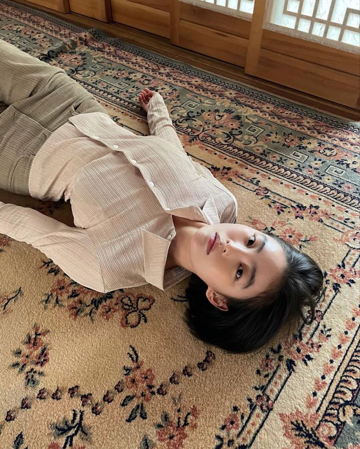 a woman laying on the floor with her legs spread out in front of her face