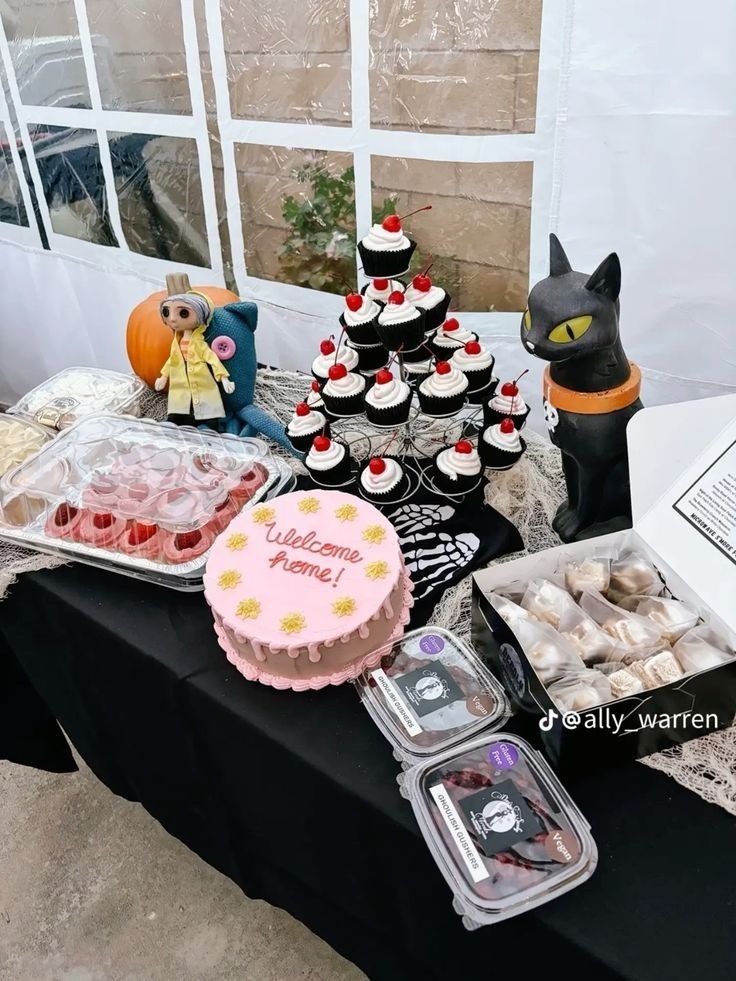 a table topped with lots of cupcakes and cakes