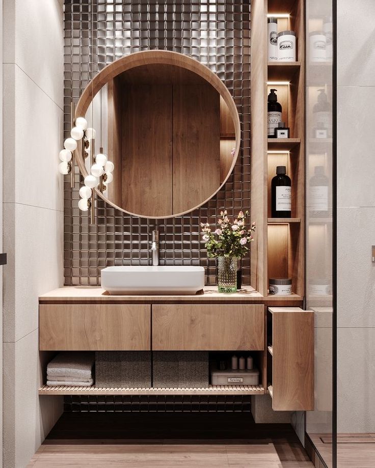 a bathroom with a sink, mirror and shelves on the wall next to each other