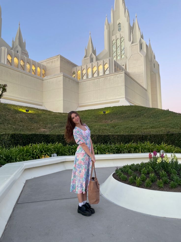 a woman standing in front of a castle