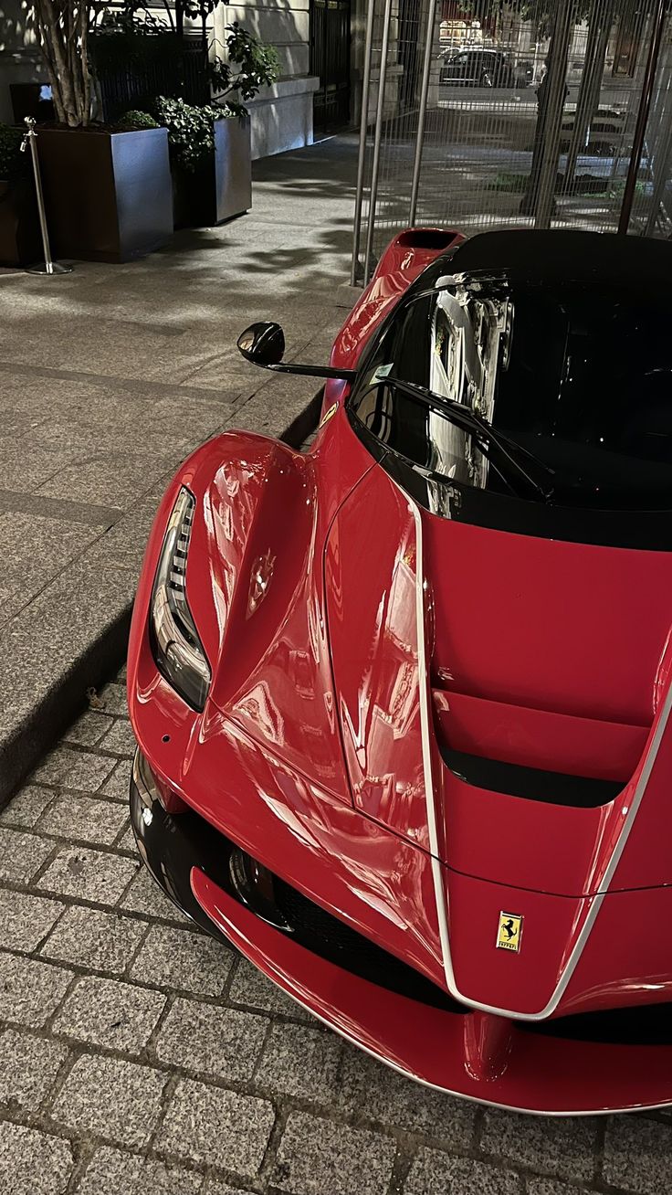 a red sports car parked in front of a building