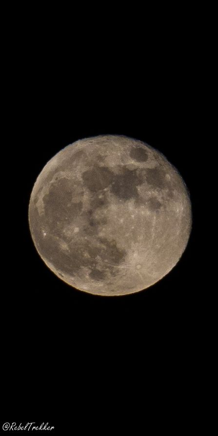 the full moon is seen in the dark sky