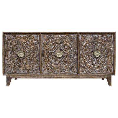 an ornate wooden sideboard with three doors