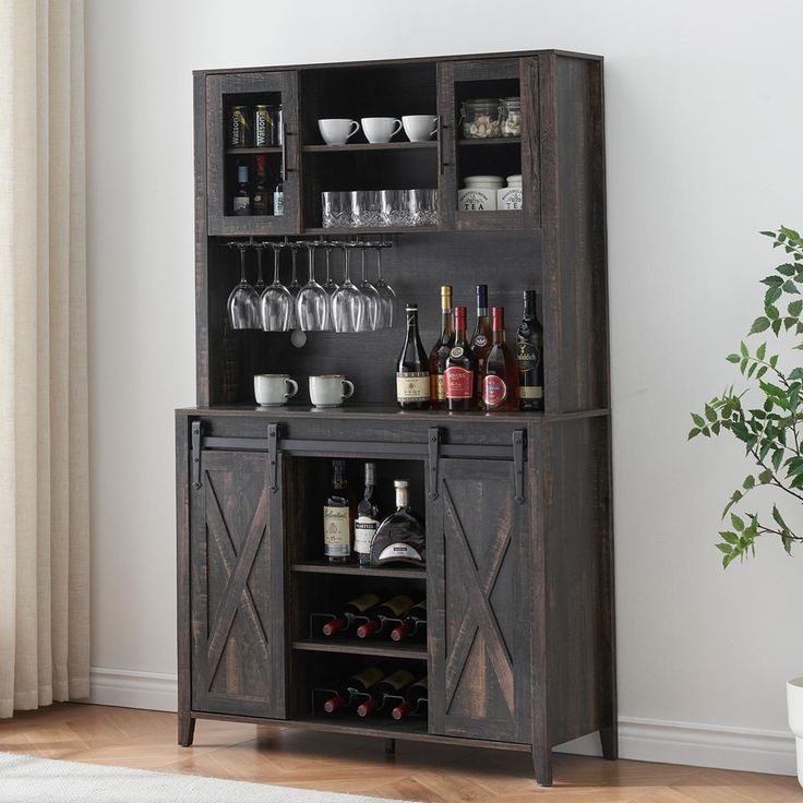 an entertainment center with wine glasses and bottles