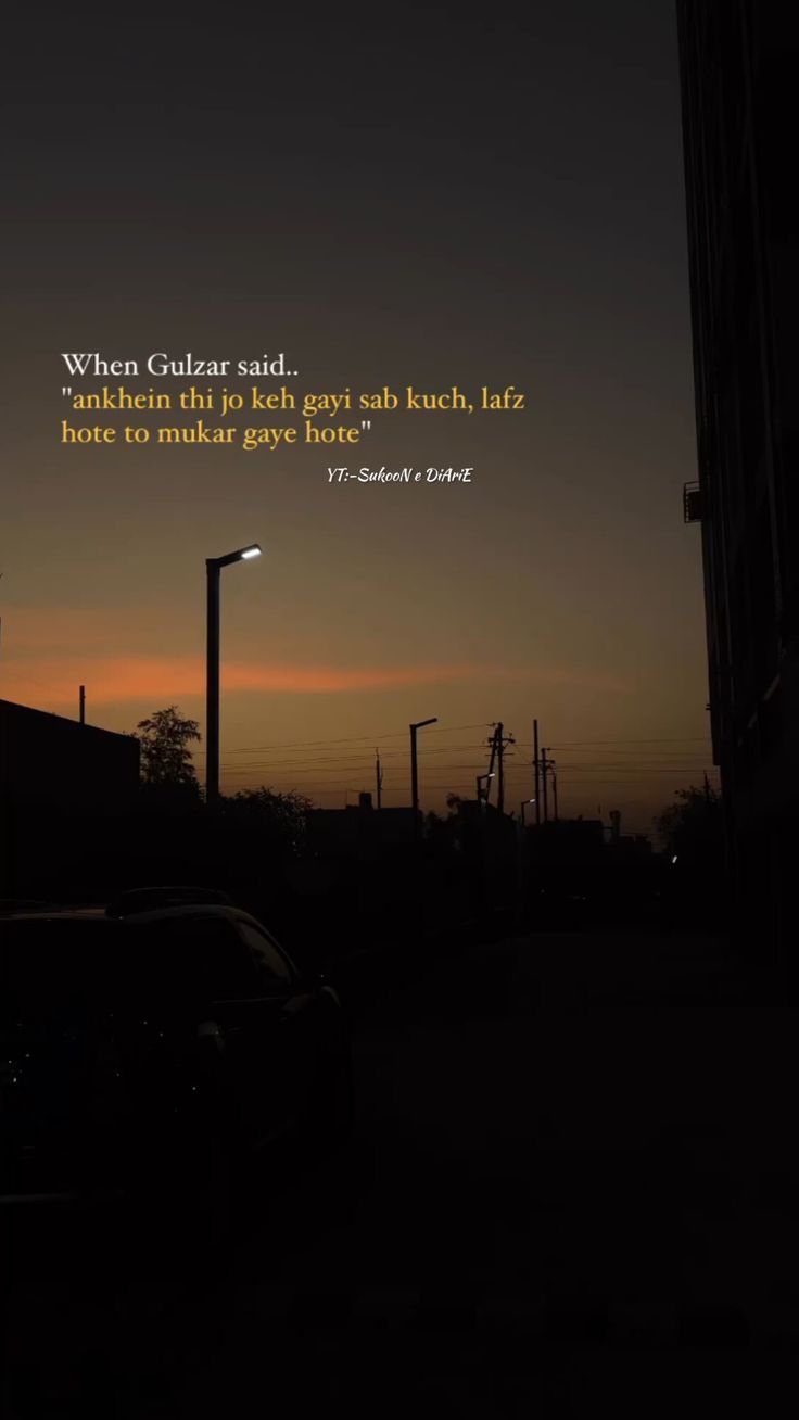 a car parked on the side of a road at night with a quote above it