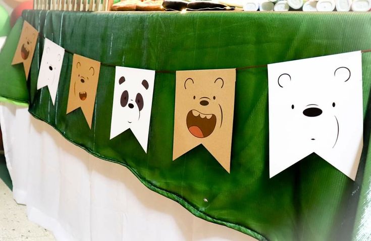 there are some paper buntings that have faces on them and one has eyes