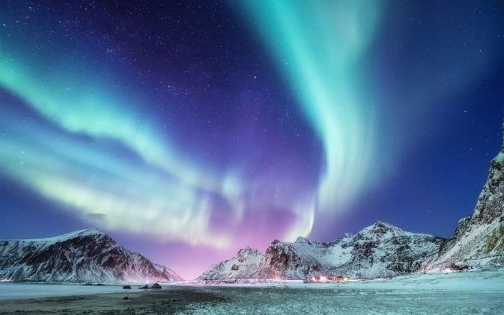 the aurora lights shine brightly in the sky above mountains