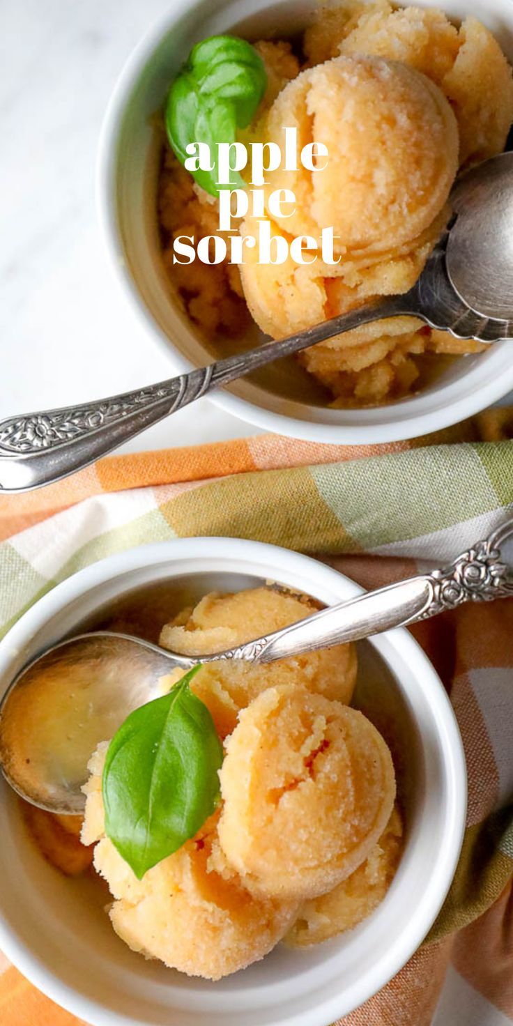 two white bowls filled with dessert on top of a checkered table cloth next to silver spoons