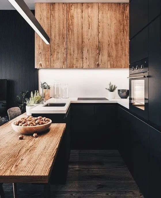 a bowl of nuts sitting on top of a wooden table next to a sink and oven