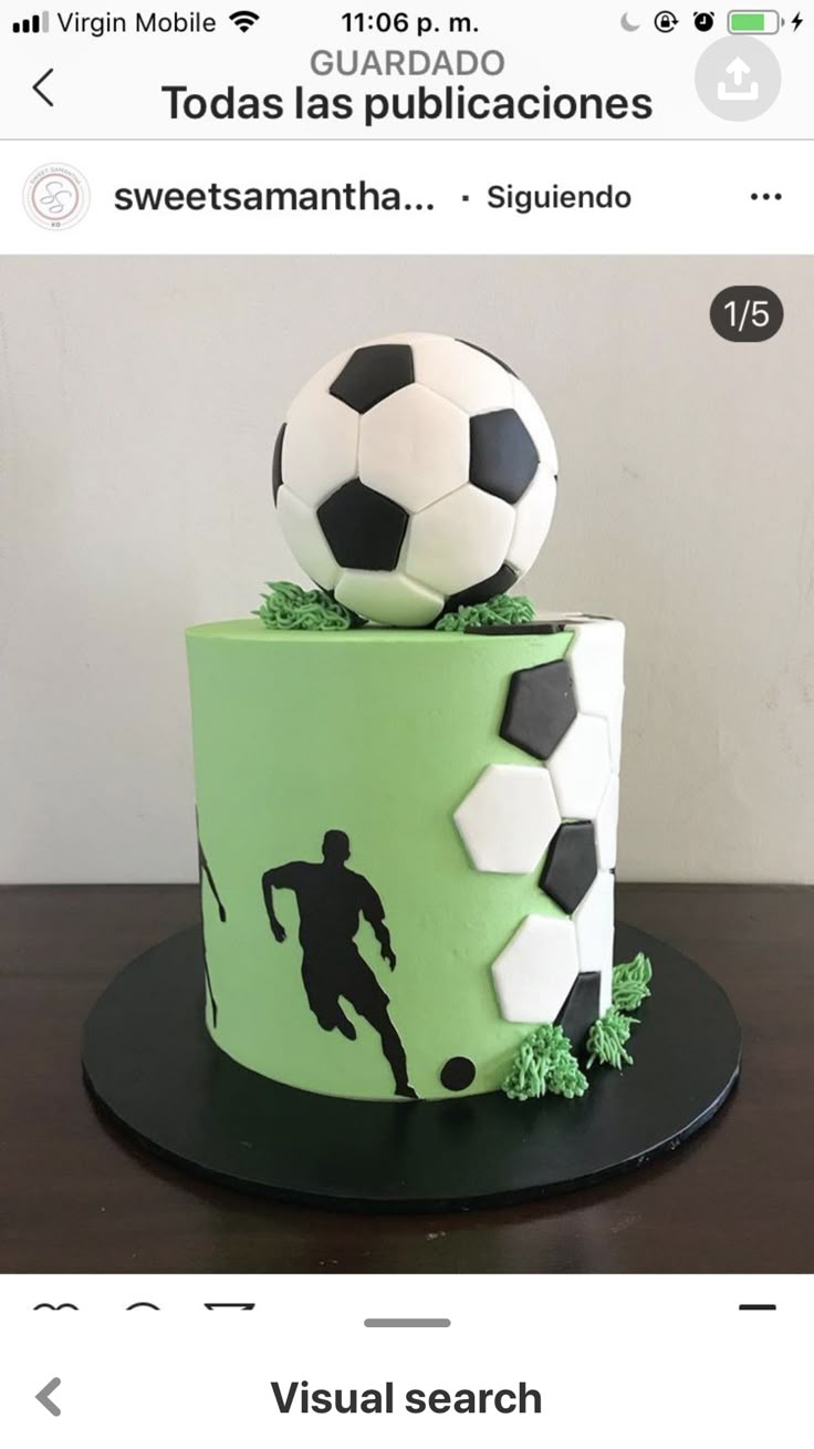 a green and white cake with a soccer ball on top