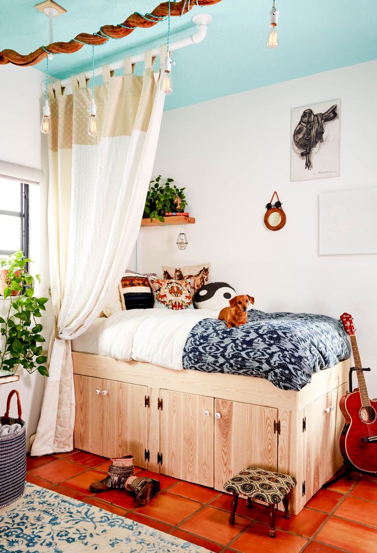 a bed room with a neatly made bed and a guitar