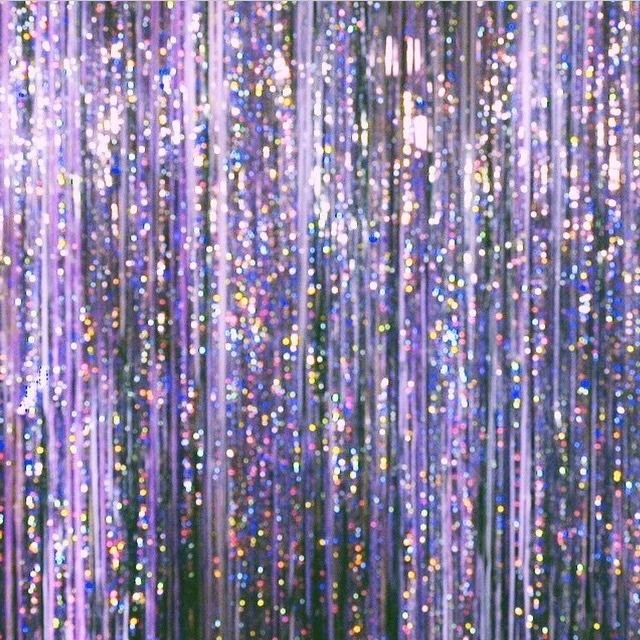 an instagram page with purple and blue glitters