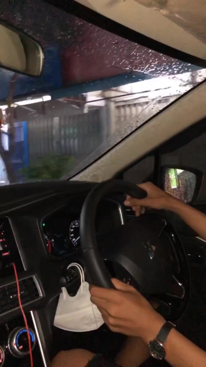 a man driving a car with his hands on the steering wheel