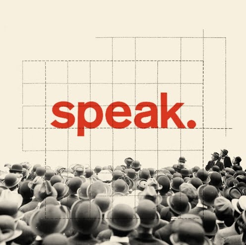 a large group of people standing in front of a screen with the word speak on it