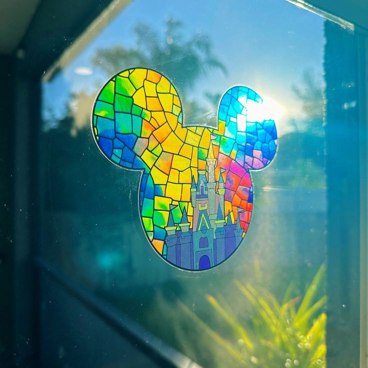 there is a colorful mickey mouse sticker on the window