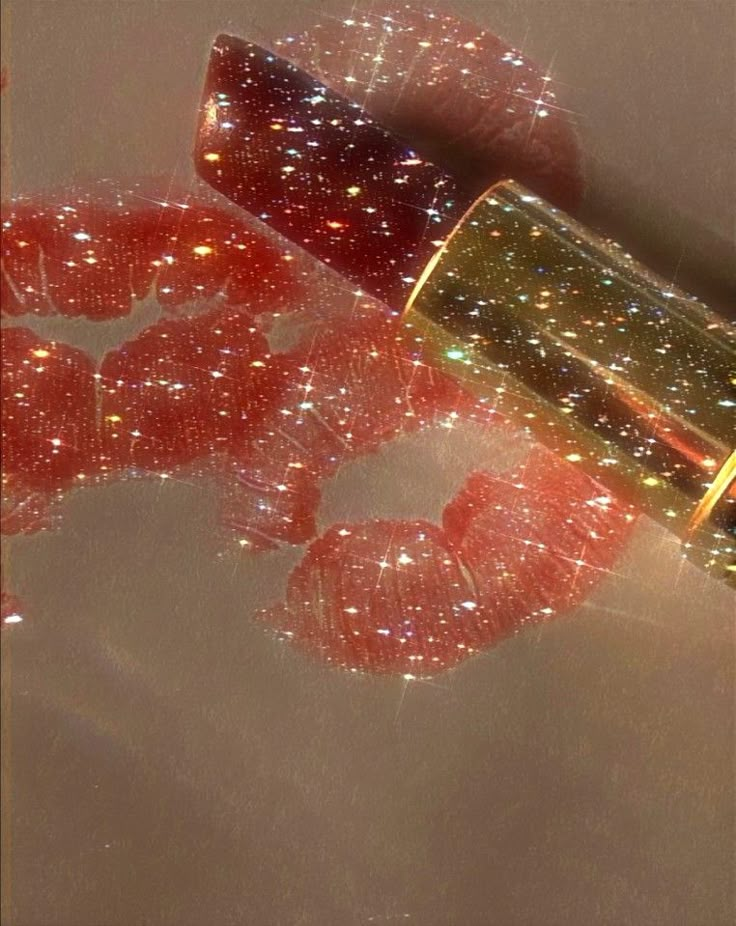 a close up of a lipstick with glitter on it