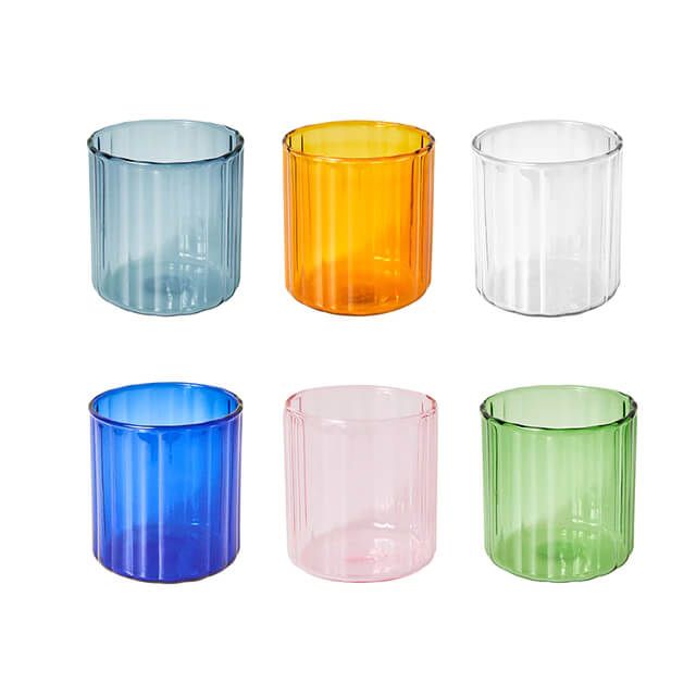 four different colored glass cups sitting next to each other