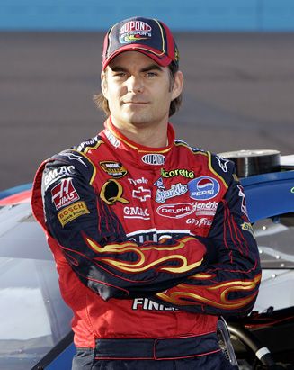 a man standing in front of a race car with a caption that reads, there's no greater feeling than winning a race jeff gordon