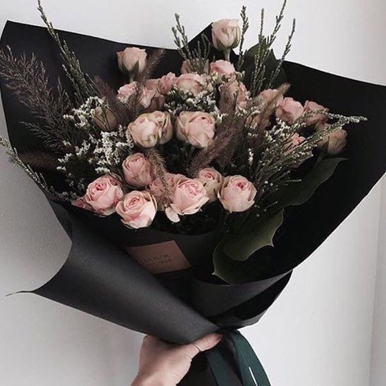 a person holding a bouquet of flowers in their hand