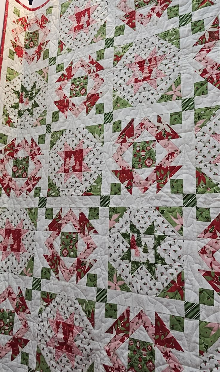 a large quilt is hanging on the wall