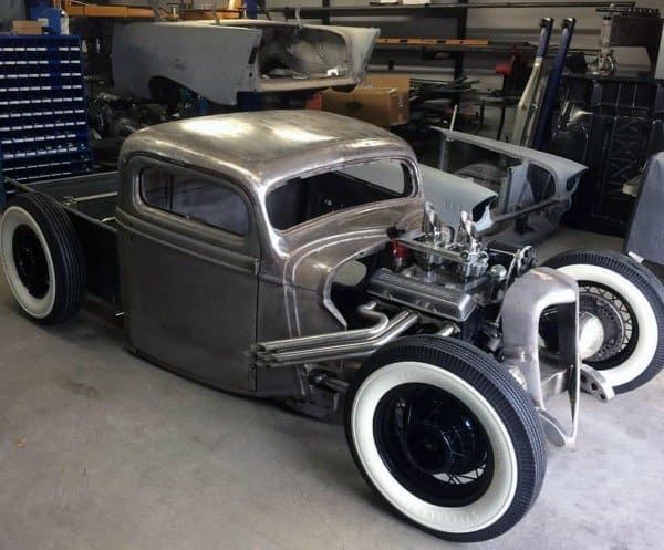 an antique car is parked in a garage