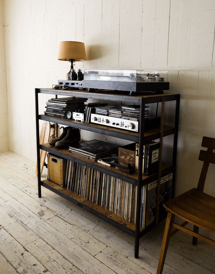 an old record player is sitting on top of a shelf in the corner of a room