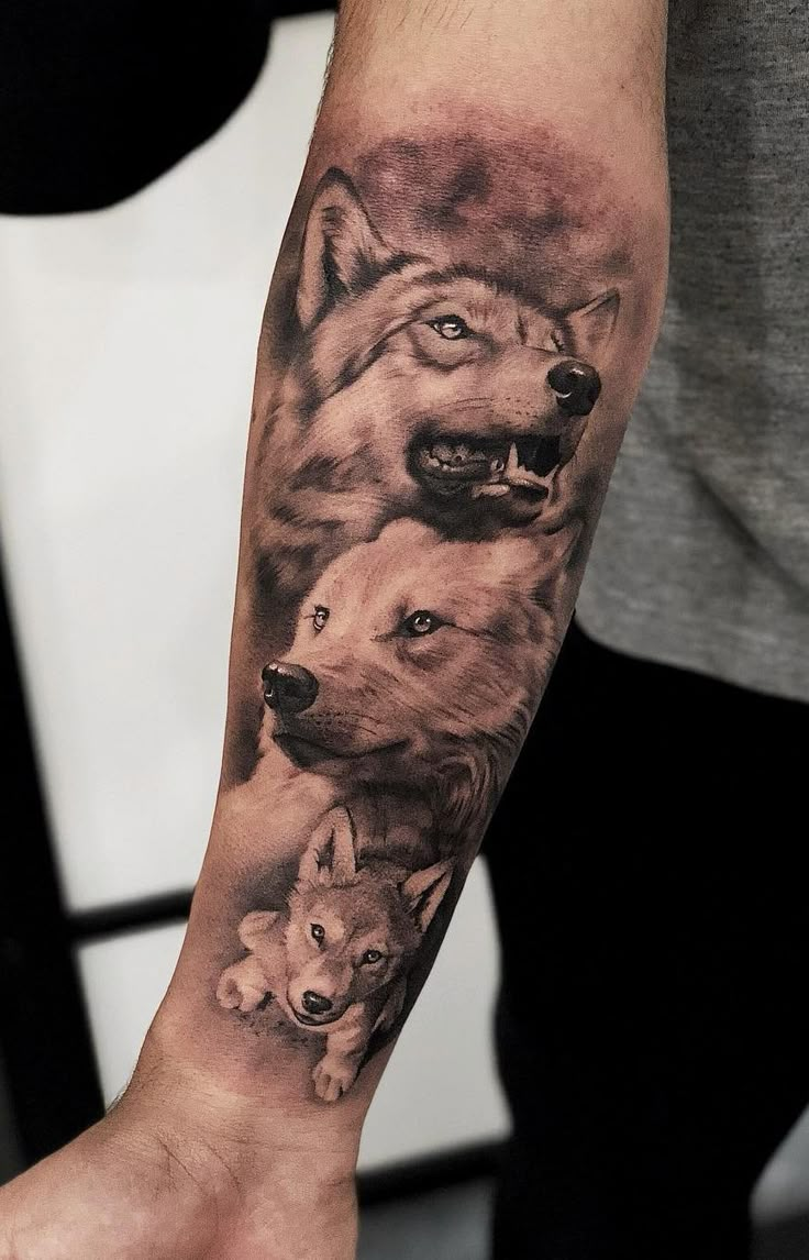 a man's arm with two wolfs on it and one is holding the other