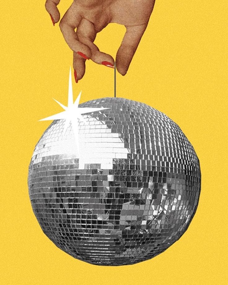 a hand reaching for a disco ball with a star on it, against a yellow background