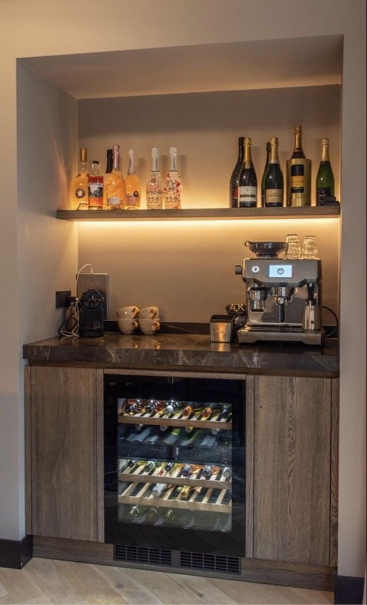 a coffee bar with various bottles on the shelves