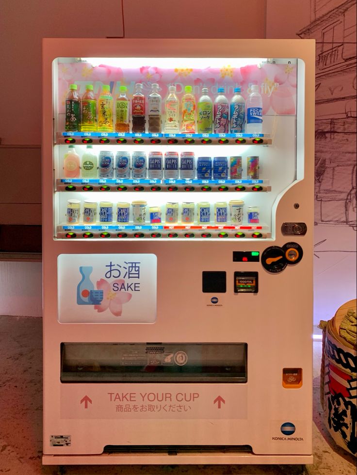 a vending machine with drinks on the front and side shelves that say take your cup