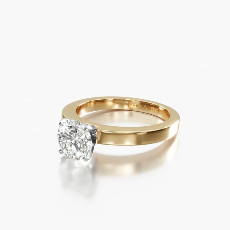 a yellow gold engagement ring with a single diamond