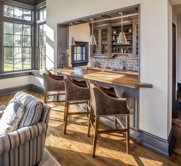 a living room filled with furniture next to a kitchen and dining room table in front of a window